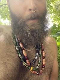 a man with a beard wearing a necklace