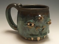 a mug with a monster face on it