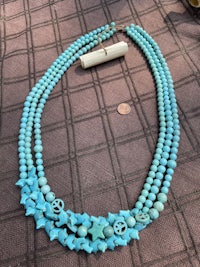 a necklace with turquoise beads and a star shaped pendant