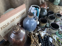 a display of pottery and other items on a table
