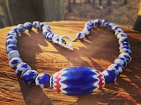 a necklace with red, white and blue beads