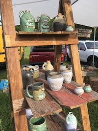 a wooden shelf with a lot of mugs on it