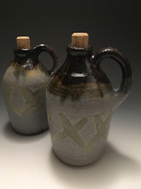 two ceramic jugs on a gray background