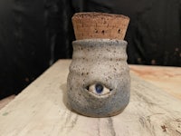 a blue jar with a blue eye on it