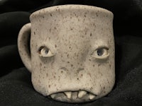 a mug with a monster face on it