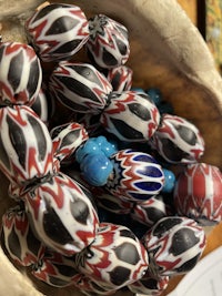 a group of beads in a bowl on a table